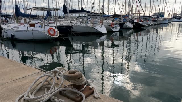 Badalona seaport, Spain, boats reflecting in the water, a place of peace and tranquility.