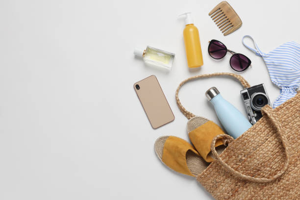 istock Wicker bag, smartphone and beach accessories on white background, flat lay. Space for text 1875188016