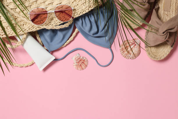 istock Flat lay composition with wicker bag and other beach accessories on pink background. Space for text 1875188032