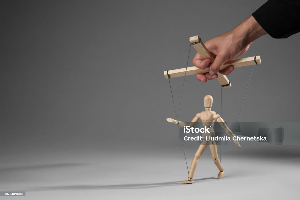 String Puppet Attacking Man Pulling Strings Of Puppet On Gray Background Closeup Space For Text ...