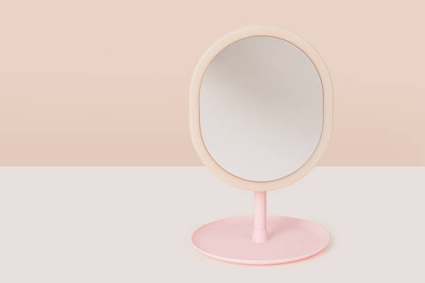 istock Pink plastic makeup cosmetic mirror isolated on light beige background 1875191714