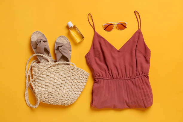istock Flat lay composition with beach bag, clothes and other accessories on orange background 1875192249