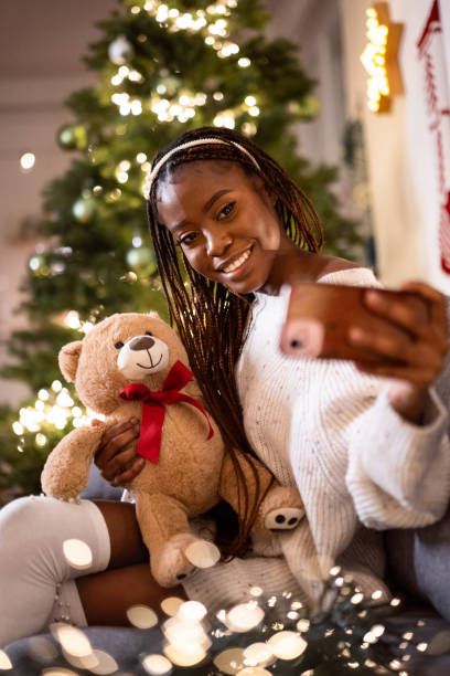 istock Woman Black ethnicity taking selfie with teddy bear 1875195393