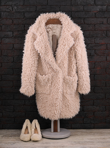 white fur coat on a hanger
