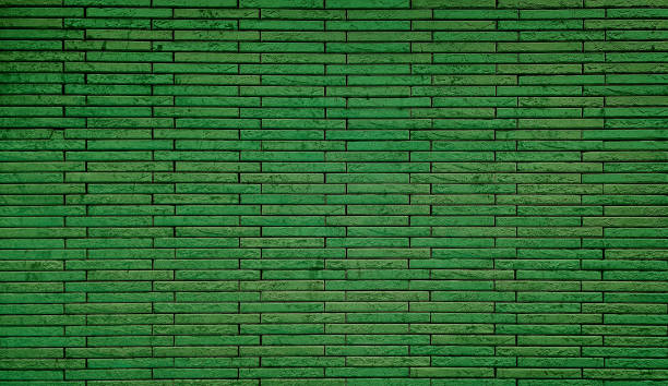 istock empty background of wide green brick wall texture. grunge green brick wall stone textured, wallpaper of limestone. grid pattern of uneven interior rock stones. wall backdrop for Christmas concept. 1875200929