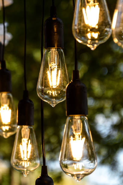 istock Electric light bulbs are lit outside the house. 1875230387