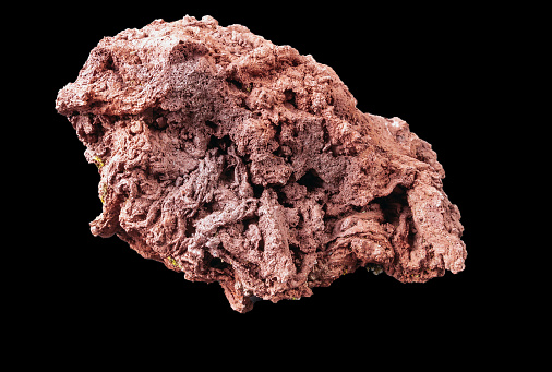 a piece of pink volcanic rock on a black background from Iceland