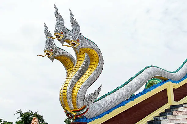Traditional Thai style  Naga statue decoration with blue sky and clouds in temple Northern of Thailand
