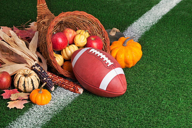 istock College style Football with a cornucopia on grass field 187528177