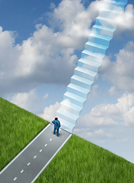 istock Man on a road looking up at stairs going into the sky 187528274