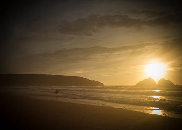 istock silhouette of a surfer at sunset 187528936