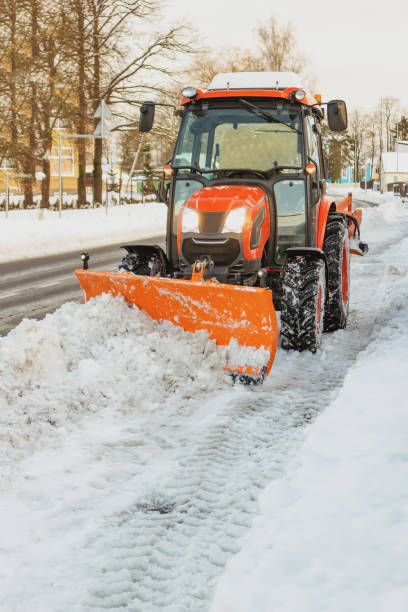 istock The tractor cleans the sidewalk in winter 1875293716