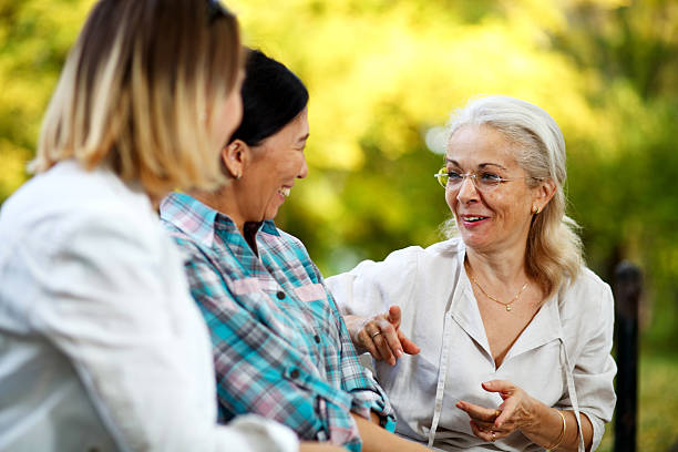 istock Elderly ladies sitting on a park bench 187529501