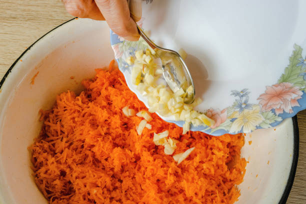 istock Garlic is poured into the grated carrots 1875295298