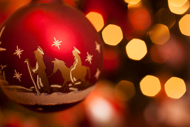 istock Christmas: Close-up of nativity scene ornament on lit tree. 187529924