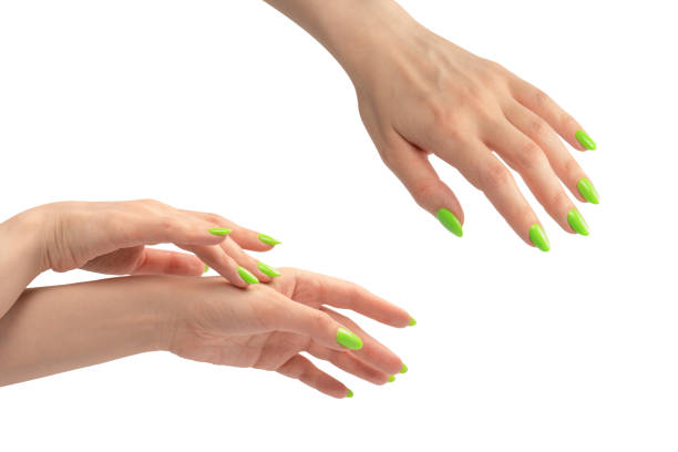 istock Hand of a woman with green naols hold some tiny or thin object. 1875312436