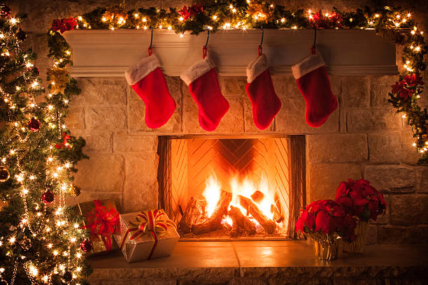 Christmas stockings, fireplace, tree, and decorations Christmas tree, decorations, lights, fireplace, mantel, hearth christmas stocking stock pictures, royalty-free photos & images