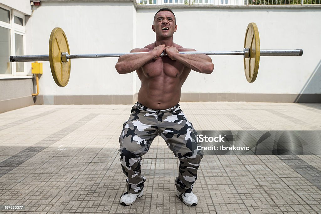 Hombre haciendo Squats frontal - Foto de stock de Adulto libre de derechos