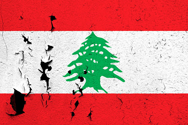 The flag of Lebanon painted on a cracked and peeling wall.