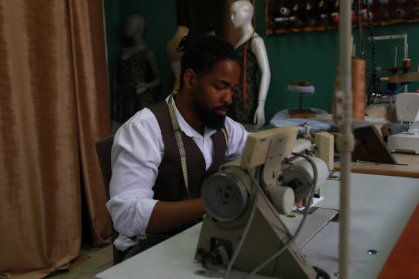 istock The tailor sits at the machine and sows 1875337542