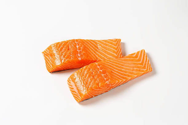 salmon fillets two raw salmon fillets isolated on white background salmon seafood stock pictures, royalty-free photos & images