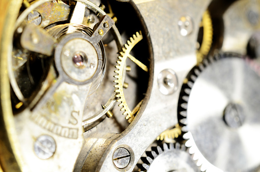 macro photo of the insides of an antique watch. gears. mechanisims.