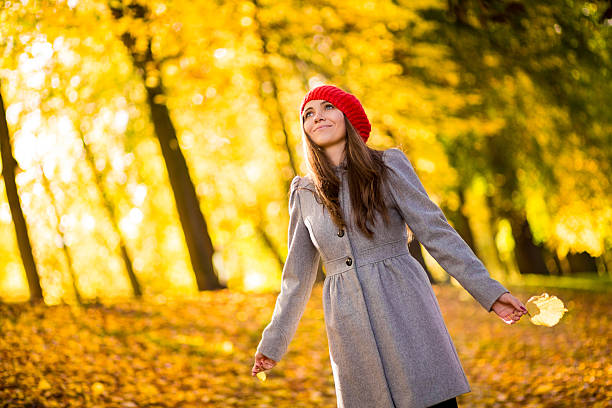 istock Woman At Park Holding Maple Leaf 187536088