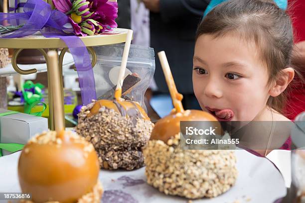 Young Excited Girl In Candy Store Looking At Caramel Apples Stock Photo - Download Image Now