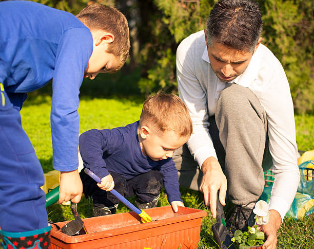 istock Family planting flowers 187537054
