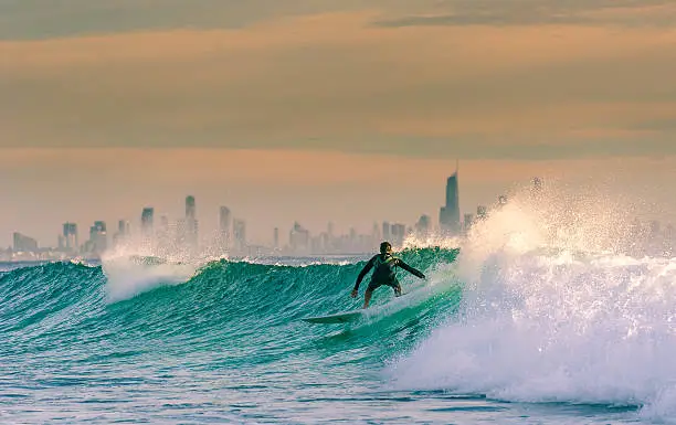 A morning surf on the gold coast. Sunrise near snapper rocks with Surfers Paradise in the background