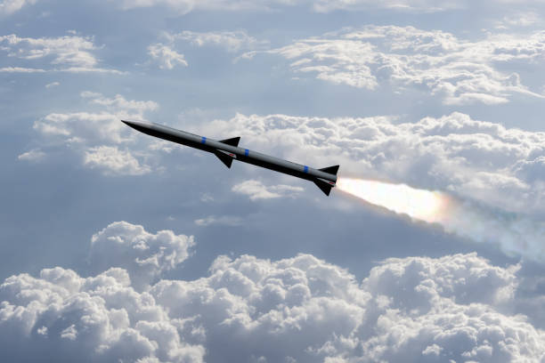 A combat rocket is flying above the clouds, smoke and fire from the rocket. Concept: missile attack, air attack