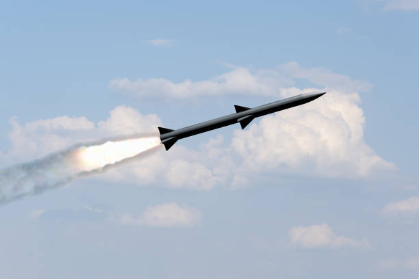istock A combat rocket is flying above the clouds, smoke and fire from the rocket. Concept: missile attack, air attack 1875400338