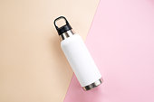 Reusable eco steel thermo water bottle on table.