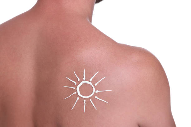 Man with sun protection cream on his back against white background, closeup