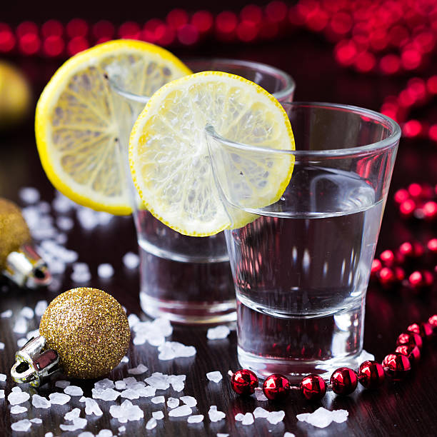 Two shots of silver tequila with salt and lemon stock photo
