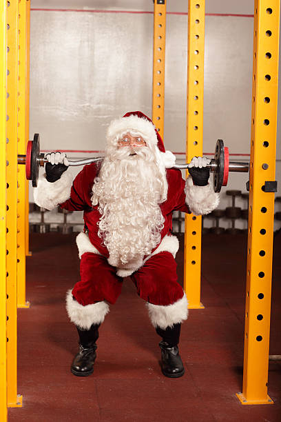 istock Santa Claus lifting weights in gym - training before Christmas 187543219