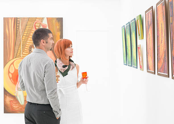 istock people looking at art gallery paintings 187543374
