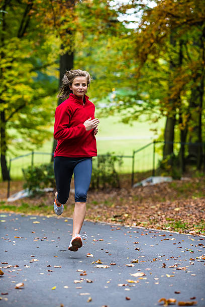 istock Woman jogging in park 187543667
