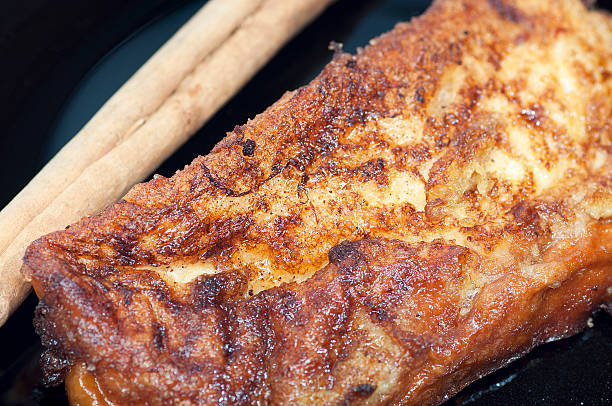 istock French toast, torrijas, and cinnamon stick on a black plate 187543718