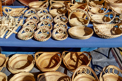 Charleston, South Carolina, USA - February 28, 2020: Sweetgrass Baskets on display at historic Charleston City Market in Charleston, South Carolina, the beautiful handicrafts of African origin.
