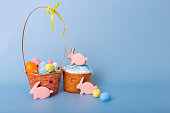 Tasty pink gingerbread in the form of a rabbit , an Easter cake and a basket with decorative eggs
