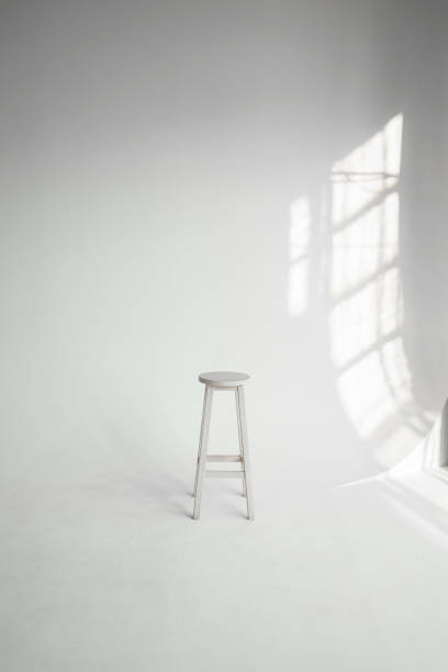 white cyclorama and stool in modern photo studio