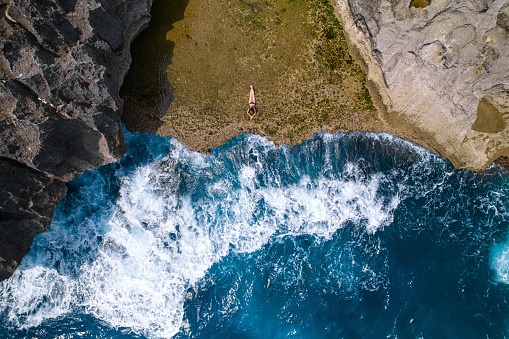 A cliff broken by an ocean wave. The cliff is washed by powerful waves of the ocean. A popular tourist destination Angel's Billabong on the island of Nusa Penida in Indonesia