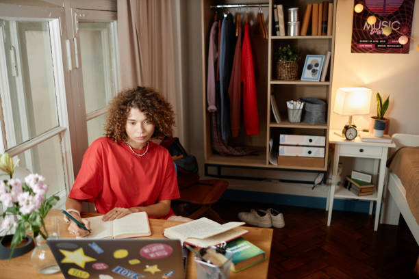 istock Girl Doing Homework in College Dorm Room 1875519089