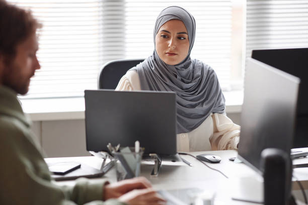 istock Middle Eastern Woman Looking at Laptop Screen in Office 1875528862