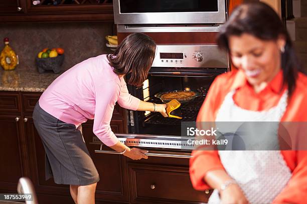 African American Women In Kitchen Cooking Dinner Stock Photo - Download Image Now - 40-49 Years, 45-49 Years, 50-59 Years