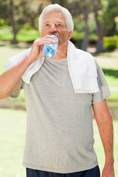 istock Man after exercise drinking water with a towel 187555777
