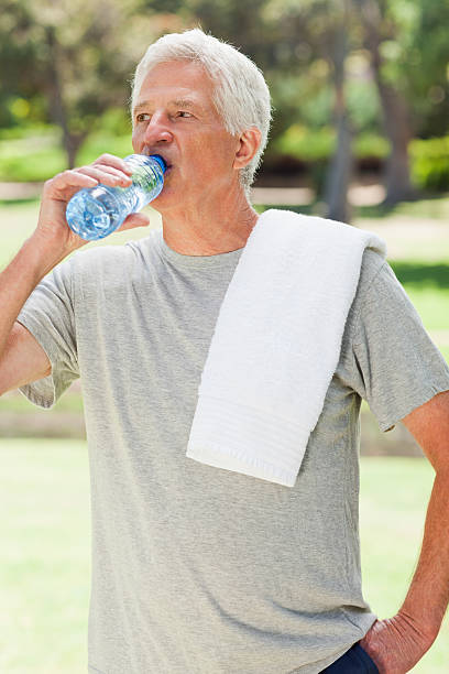 istock Man drinking water has a towel over his shoulder 187555801