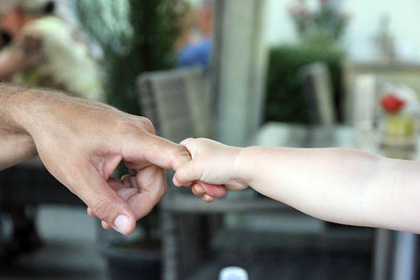 istock hands  of the child and father 187557959