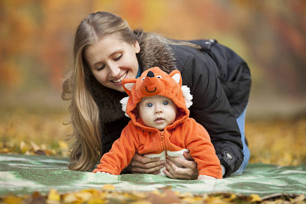 Young woman with baby dressed in fox costume